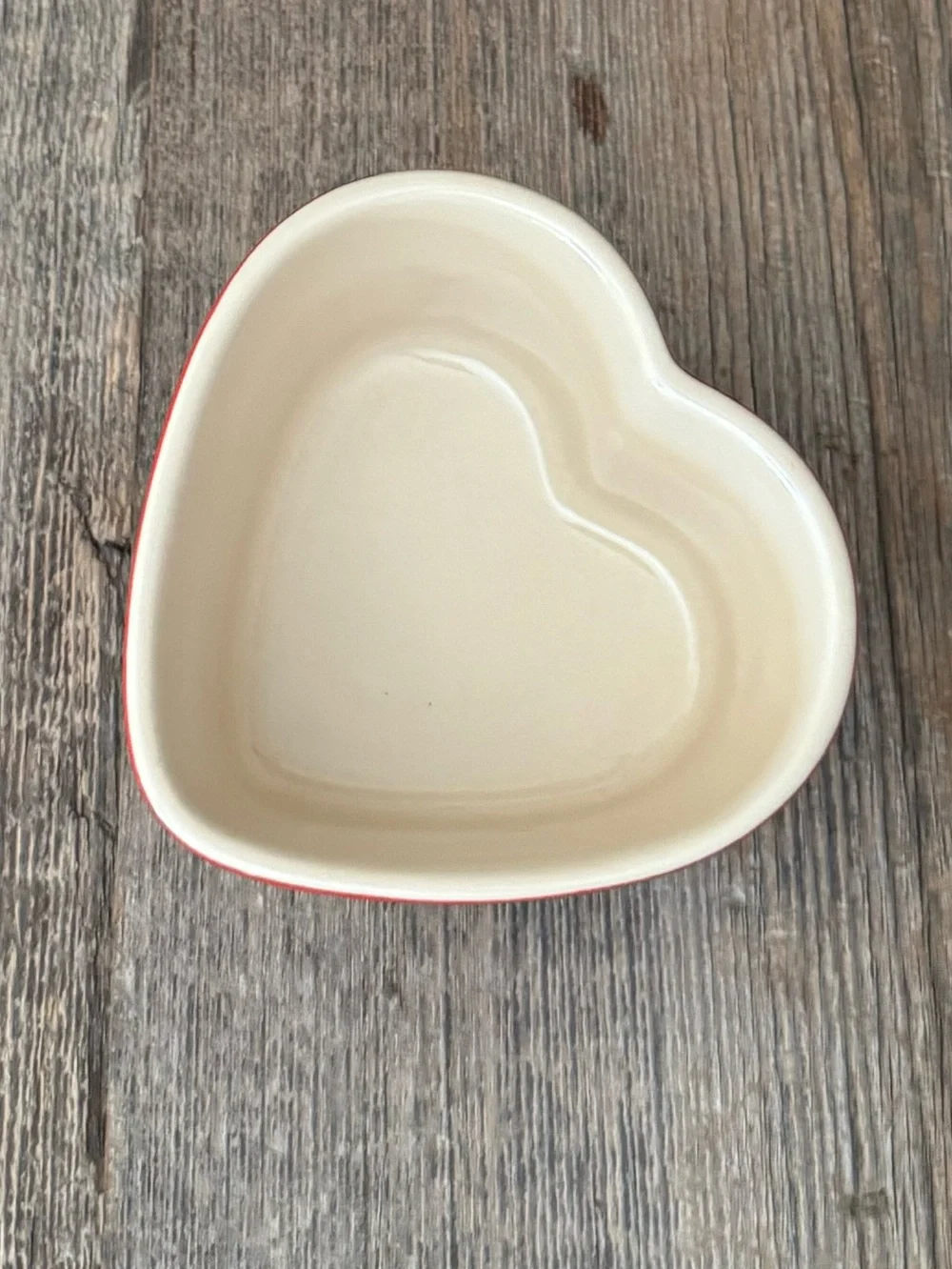 Red Le Creuset heart-shaped stoneware ramekin